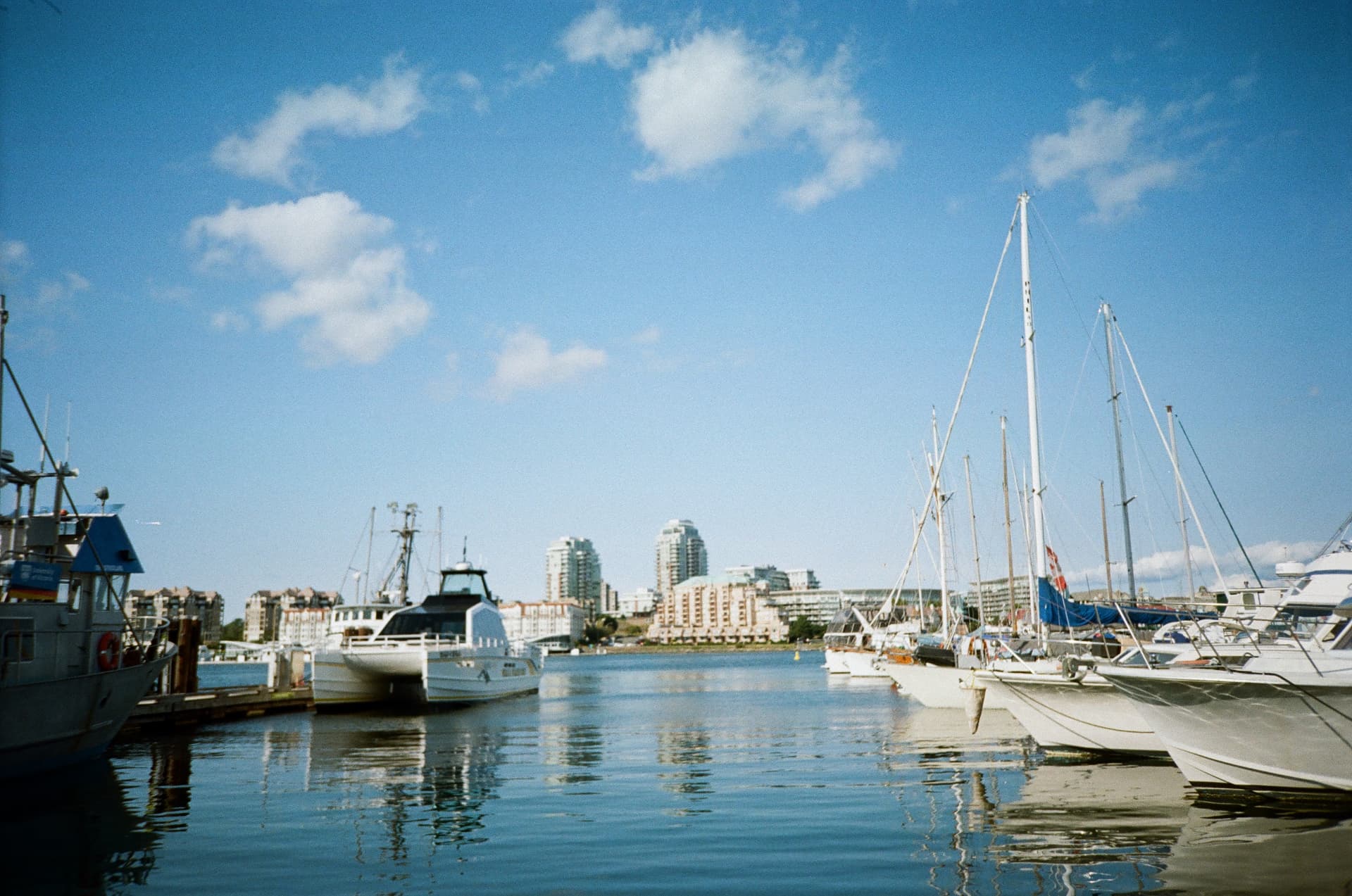 Boats moored in the inner harbour under a blue sky